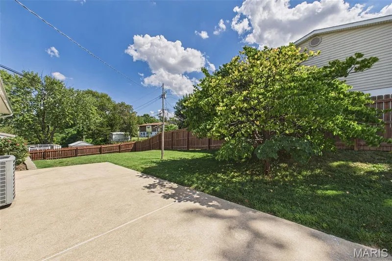The large, fenced backyard has a big patio for backyard activities and relaxing. — 656 Nancy Drive, St Charles, MO 63301