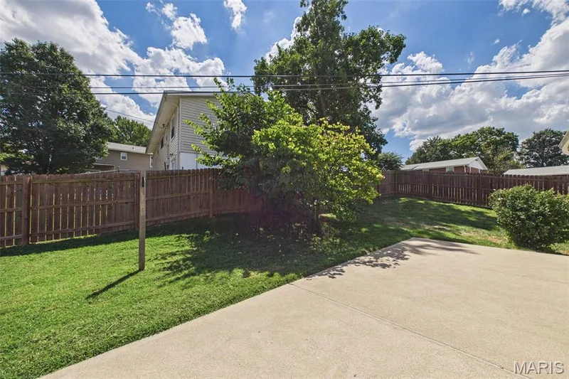 The backyard has a large patio, and a privacy fence for relaxing and private entertaining — 656 Nancy Drive, St Charles, MO 63301