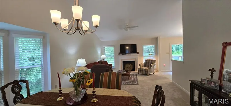 Stunning vaulted great room with soaring ceilings.  Gas fireplace and bay window.  This home offers 3 bay windows and  2 sets of plantaion shutters.  updated lighting in greatroom and Kitchen area.  Carpeting and paint recent in 2025. — 30 Sterling Pointe Drive #22A, St Charles, MO 63301