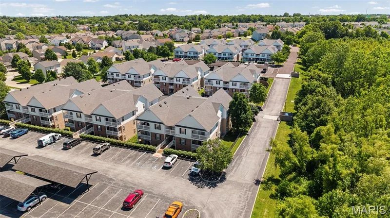 Multi-unit residential complex featuring multiple buildings with private balconies and gabled roofs — 1233 Saravalle Drive, St Peters, MO 63376