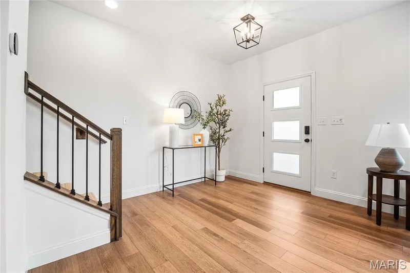 Entrance foyer featuring light wood-style floors, stairway, a chandelier, and recessed lighting — 170 Sesame Loop, St Peters, MO 63303