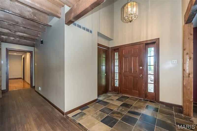 Entryway with baseboards, a towering ceiling, beam ceiling, and a chandelier — 2731 Christy Avenue, Wildwood, MO 63040