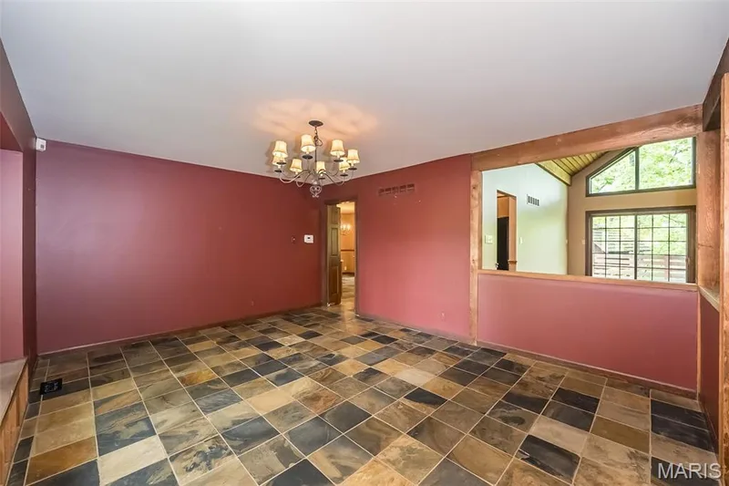 Unfurnished room with a chandelier and stone finish flooring — 2731 Christy Avenue, Wildwood, MO 63040