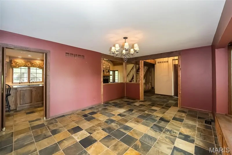 Unfurnished dining area with a chandelier, healthy amount of natural light, and stone finish floors — 2731 Christy Avenue, Wildwood, MO 63040