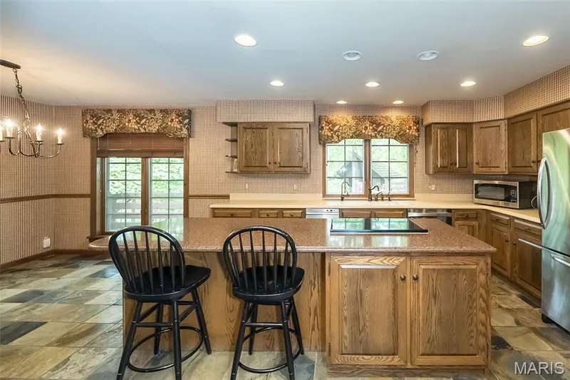 Kitchen with stainless steel appliances, a center island, a chandelier, a breakfast bar, and recessed lighting — 2731 Christy Avenue, Wildwood, MO 63040