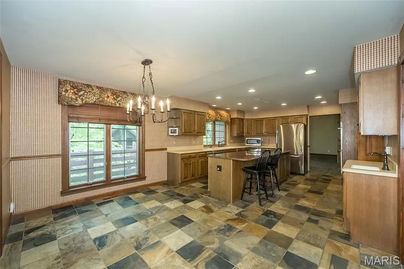Kitchen with stainless steel appliances, a sink, a chandelier, a kitchen island, and recessed lighting — 2731 Christy Avenue, Wildwood, MO 63040