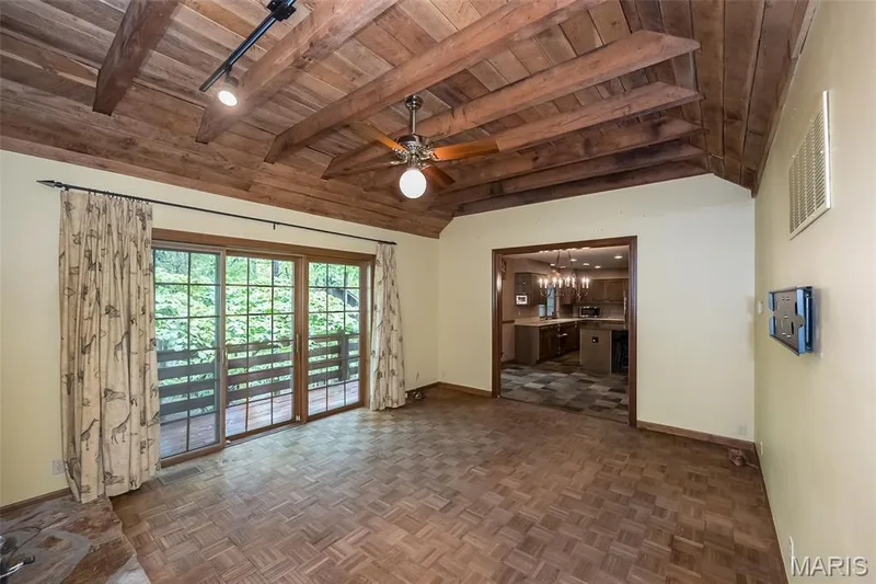 Unfurnished living room with wooden ceiling, baseboards, and ceiling fan — 2731 Christy Avenue, Wildwood, MO 63040