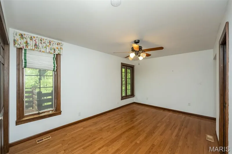 Unfurnished room with light wood finished floors, ceiling fan, and baseboards — 2731 Christy Avenue, Wildwood, MO 63040