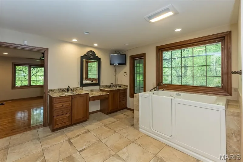 Bathroom featuring recessed lighting, a bath, vanity, tile patterned flooring, and baseboards — 2731 Christy Avenue, Wildwood, MO 63040