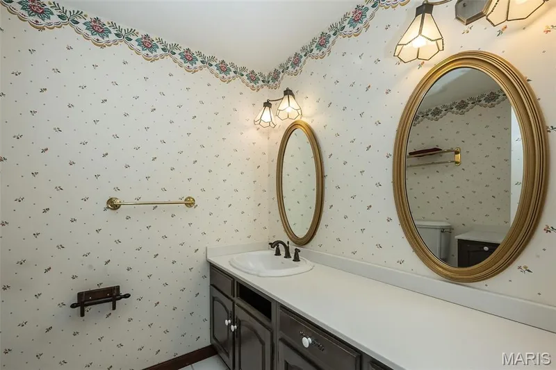 Bathroom featuring vanity, toilet, and wallpapered walls — 2731 Christy Avenue, Wildwood, MO 63040
