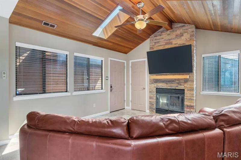 Vaulted wood-paneled ceiling with a skylight and ceiling fan — 309 Hemingway Lane, Weldon Spring, MO 63304