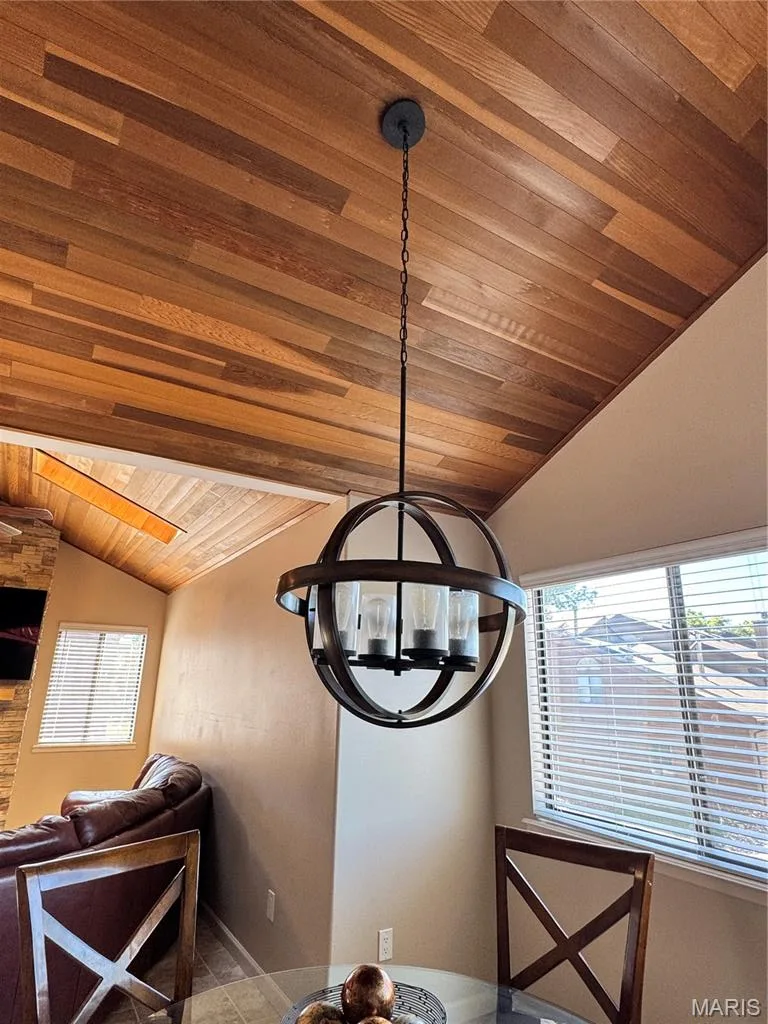 Vaulted wood-finish plank ceiling featuring a spherical chandelier with exposed filament bulbs — 309 Hemingway Lane, Weldon Spring, MO 63304