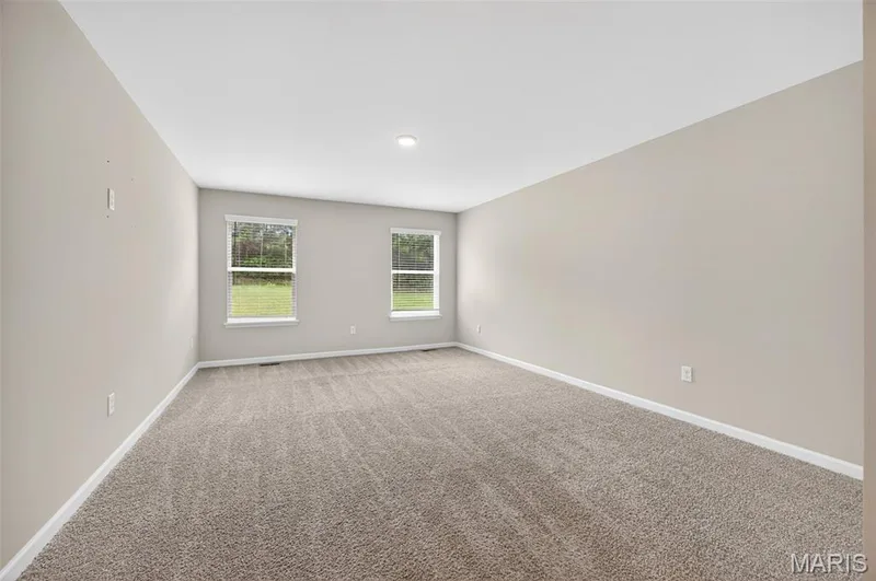 Spacious interior featuring neutral carpeting, light-toned wall paint, and white trim — 112 Creek Haven Court, Lake St. Louis, MO 63367
