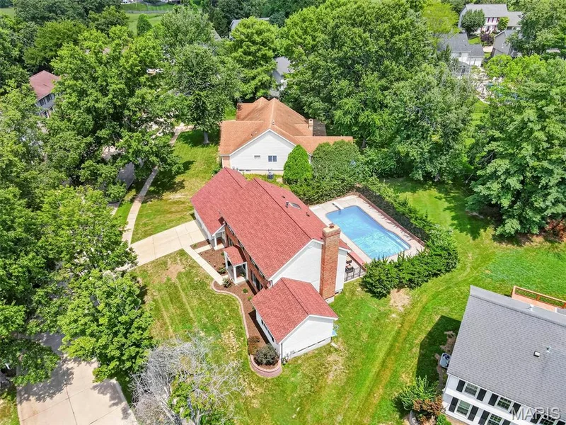 Look at this lot!  You've got great patio space, a huge pool, yard beyond the pool, and then through those trees, usable, mowed and maintained common ground! — 2024 Meadowbrook Way Drive, Chesterfield, MO 63017