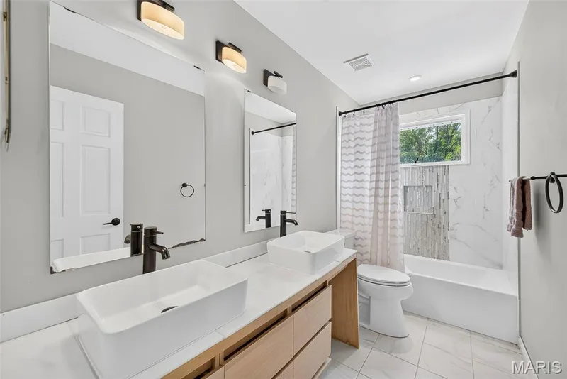 Hall bathroom with double sinks, and custom tiled tub/shower combination. — 2024 Meadowbrook Way Drive, Chesterfield, MO 63017