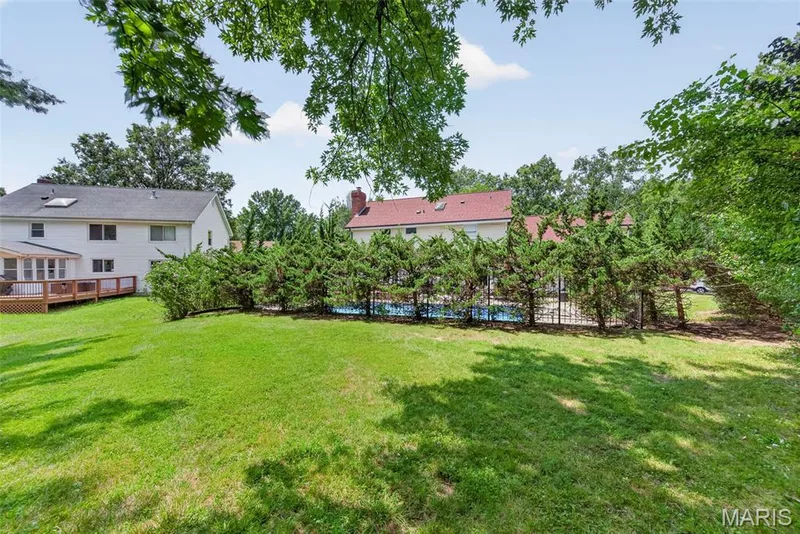 The yard extends beyond the back fence/tree line at the pool. — 2024 Meadowbrook Way Drive, Chesterfield, MO 63017
