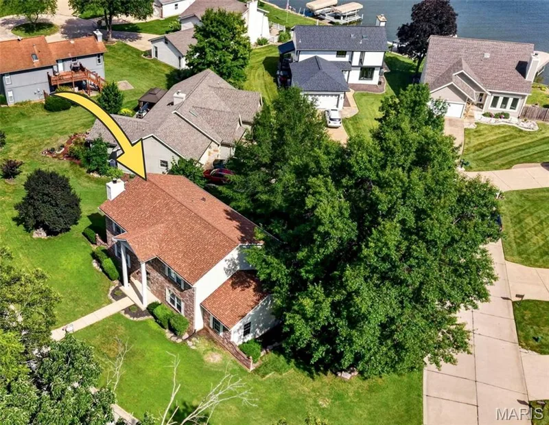 Lake view through neighboring homes. Upstairs has lake view when trees are cleared. — 110 Antoinette Terrace, Lake St. Louis, MO 63367