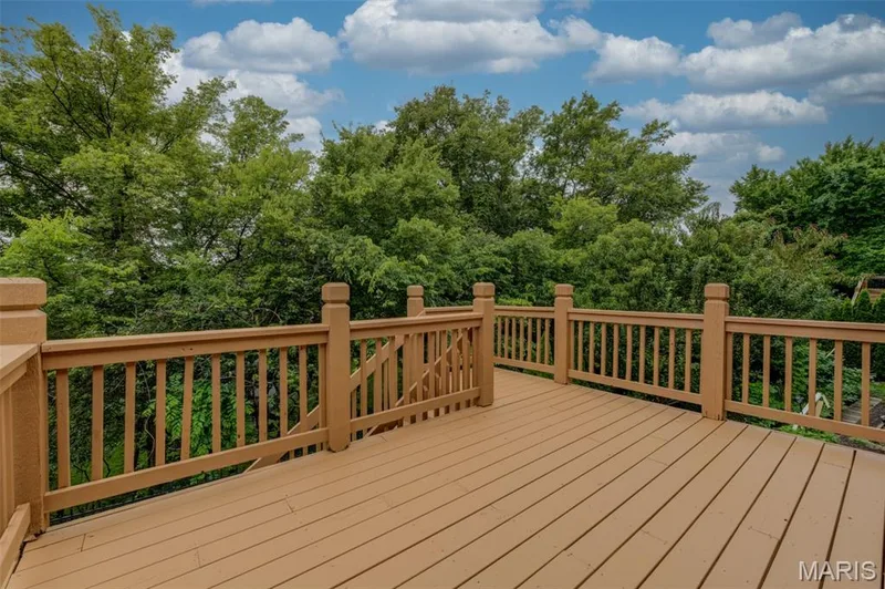 New floor boards and freshly applied stain with backdrop of greenery — 508 Newkirk Circle, St Peters, MO 63303