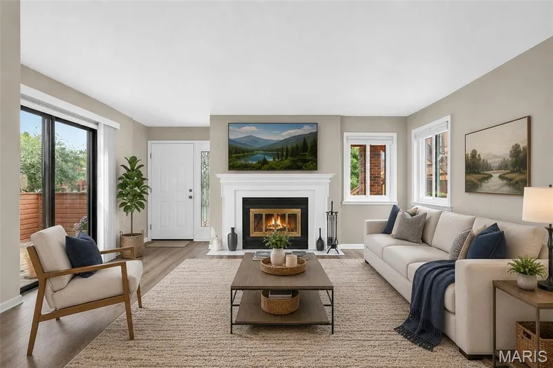 STAGED - Living Room w/ front door & sliding glass door to private patio. — 408 Kipling Way #A, Weldon Spring, MO 63304