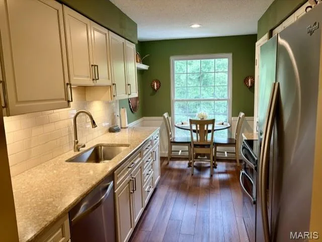 Updated kitchen with white cabinets, stainless steel appliances, hard surface counters. — 1525 Hampton Hall Drive #22, Chesterfield, MO 63017