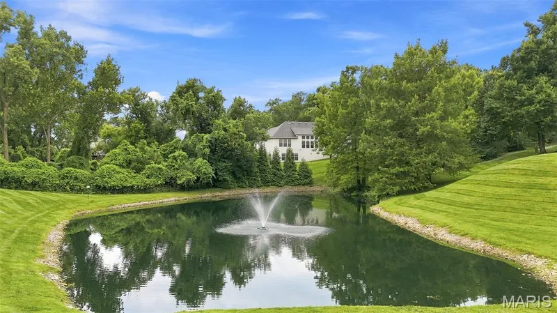 Enjoy a stroll around the pond. This is part of extensive manicured grounds with mature trees. — 1525 Hampton Hall Drive #22, Chesterfield, MO 63017