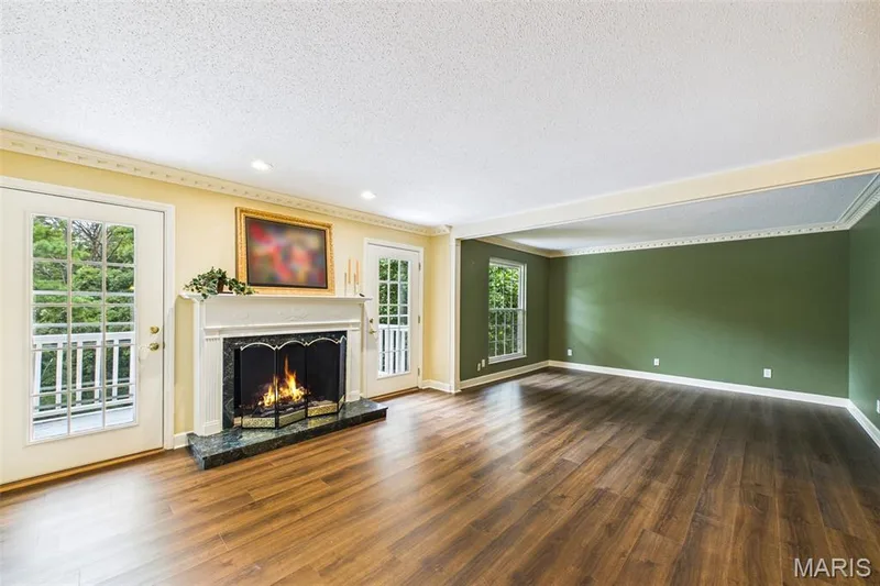Beautiful gas fireplace with doors to private deck. gleaming wood-like flooring 2026Note this unite has zoned HVAC. — 1525 Hampton Hall Drive #22, Chesterfield, MO 63017