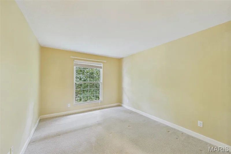 Second bedroom with pale carpet and large walk in closet. — 1525 Hampton Hall Drive #22, Chesterfield, MO 63017