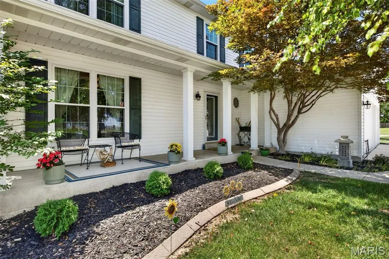 Covered porch with columns and established landscaping — 7296 Picasso Drive, Dardenne Prairie, MO 63368