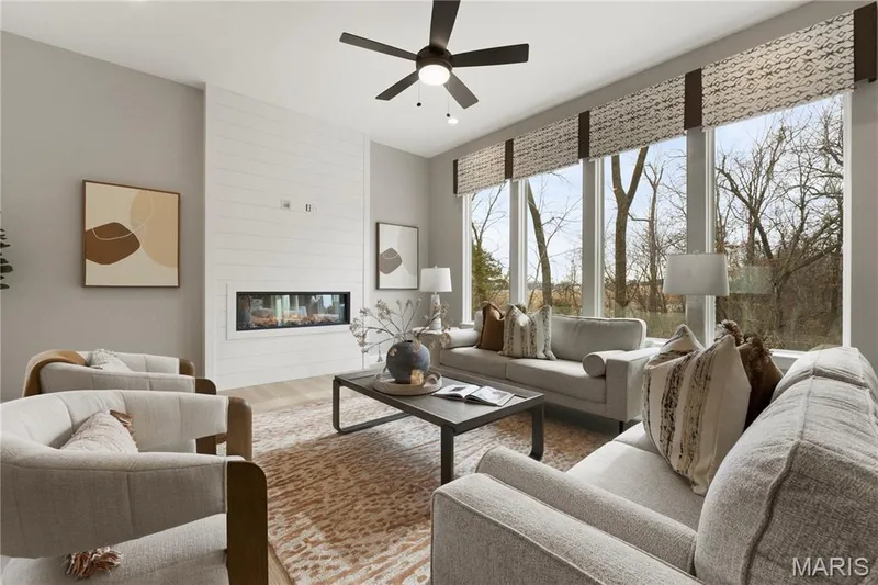 Great Room with a 2 ft Volume Ceiling, Ceiling Fan, Window Wall and Electric Fireplace — 14 Cedarstone Court, Dardenne Prairie, MO 63368