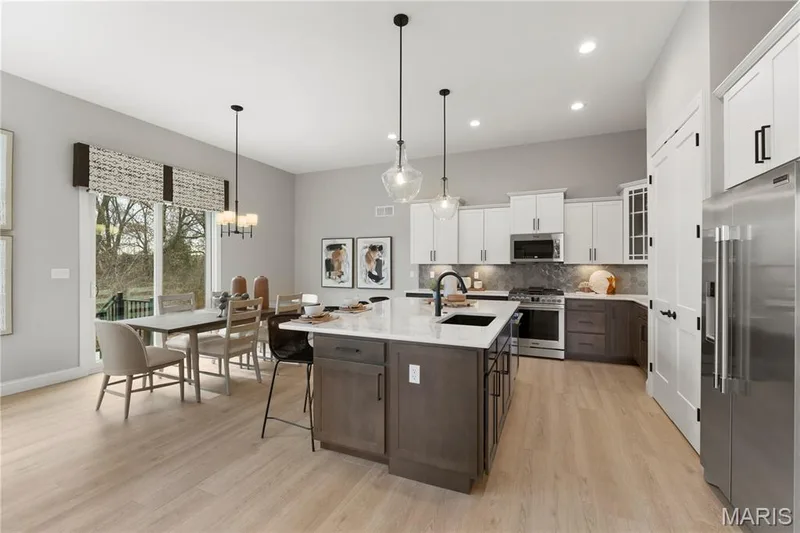Kitchen with custom Two Tone Cabinets, Stainless Steel Gas appliances and Quartz Countertops — 14 Cedarstone Court, Dardenne Prairie, MO 63368