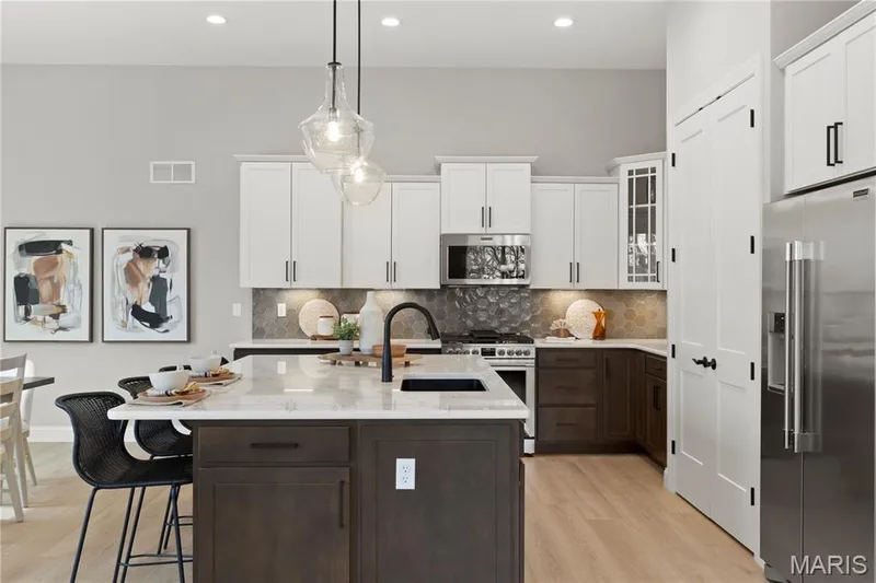 Kitchen with custom Two Tone Cabinets, Stainless Steel Gas appliances and Quartz Countertops — 14 Cedarstone Court, Dardenne Prairie, MO 63368