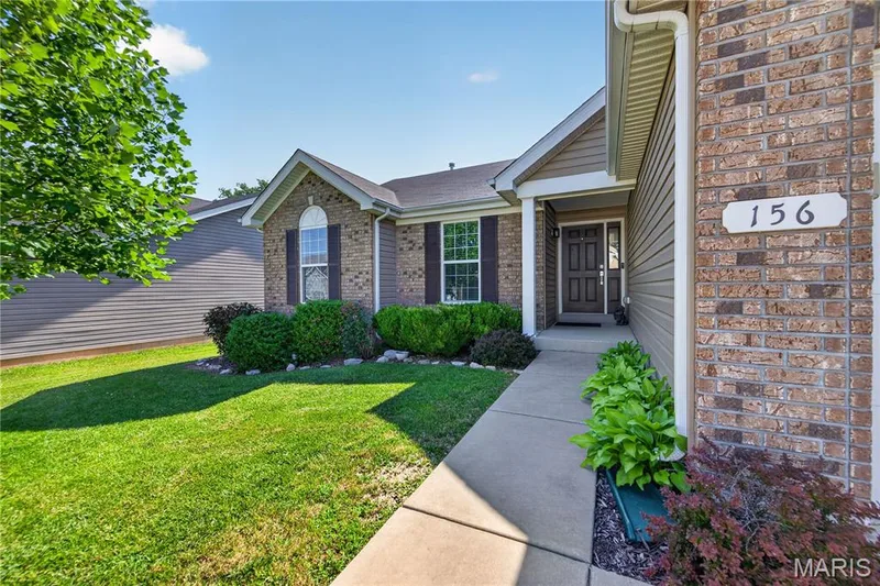 Concrete Walkway with Landscaping leads to the Covered Front Porch! — 156 Hidden Bluffs Drive, Lake St. Louis, MO 63367