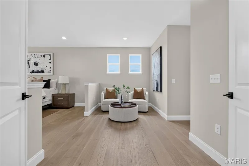 Main floor Primary Bedroom featuring a sitting area — 26 Valor Way, O'Fallon, MO 63385