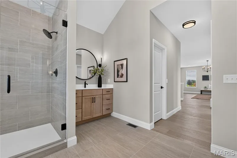 Walk-in shower with tile surround and glass enclosure — 26 Valor Way, O'Fallon, MO 63385