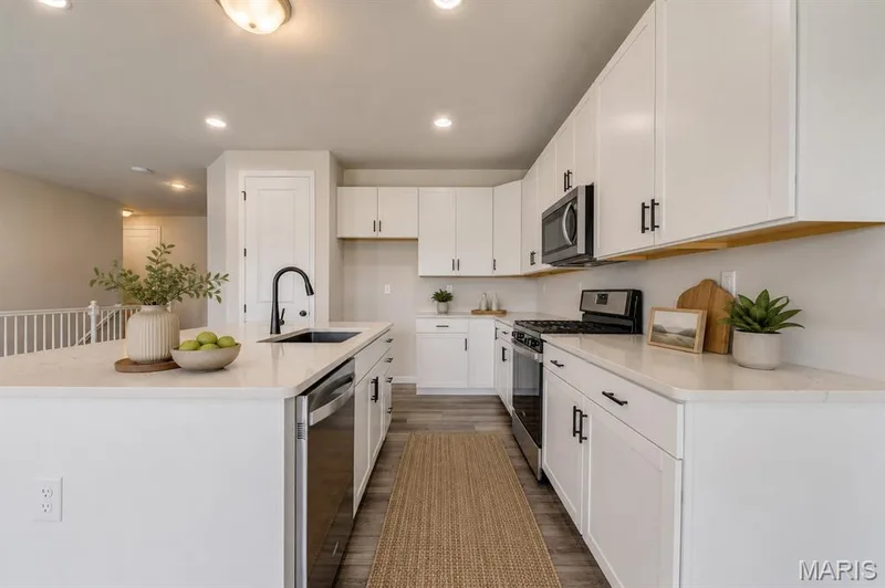 Virtual staged kitchenQuartz countertop , soft close cabinets, gas cooktop — 118 Riding Crop Lane, Wentzville, MO 63385