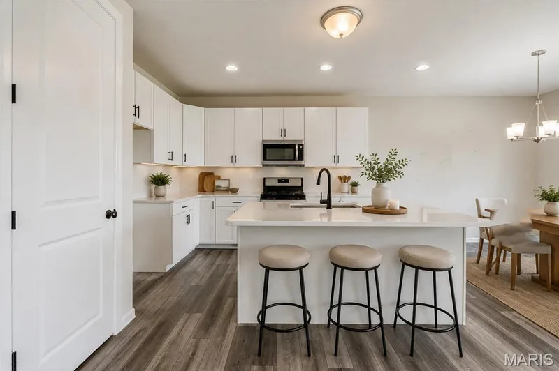 Virtual Staged kitchenwith breakfast bar, spacious pantry, stainless steel appliances — 118 Riding Crop Lane, Wentzville, MO 63385