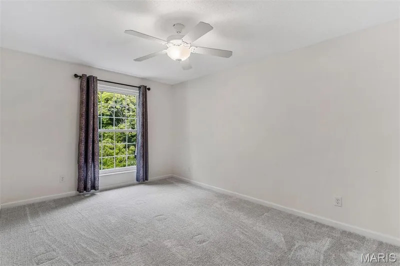 Recessed window with white trim, a ceiling fan with integrated lighting, and light grey carpeting — 1511 Hampton Hall Drive #10, Chesterfield, MO 63017