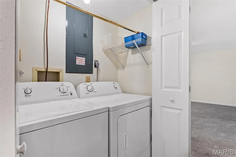 Dedicated laundry space with wire shelving — 1511 Hampton Hall Drive #10, Chesterfield, MO 63017