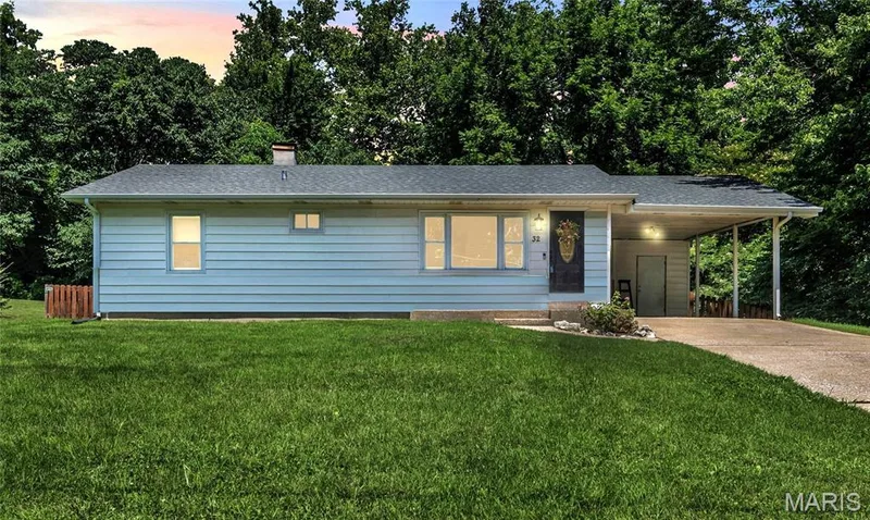 Twilight photo. Siding color is white. — 32 Highland Drive, St Charles, MO 63303