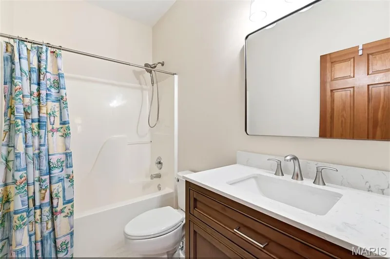 Bathroom featuring a vanity with a white rectangular undermount sink, a white countertop, and a brushed nickel widespread faucet — 3515 Truman Terrace Drive #65, St Charles, MO 63301