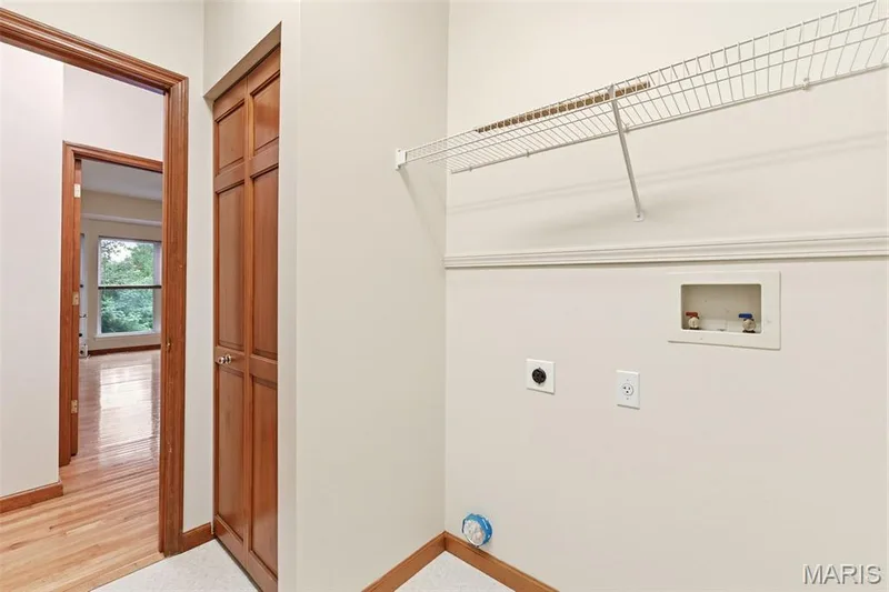 Dedicated utility space featuring a wire shelving unit, appliance hookups, and a panel door closet — 3515 Truman Terrace Drive #65, St Charles, MO 63301