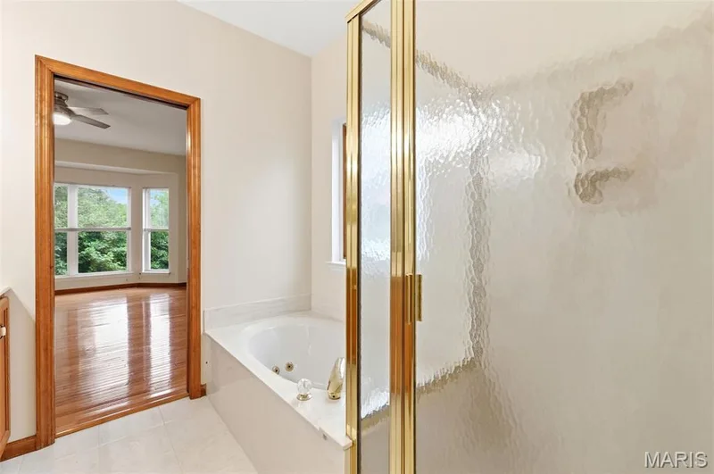 Soaking tub with a white marble-look surround — 3515 Truman Terrace Drive #65, St Charles, MO 63301