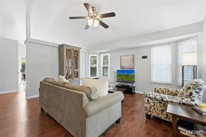 Living area featuring wood-finish flooring, light gray walls, and white trim — 2510 Balaji Court, Wildwood, MO 63011