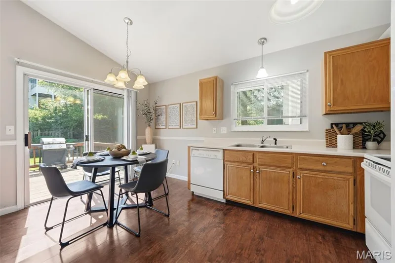 Kitchen with wood-finish flooring, light wood cabinetry, and a white countertop — 2510 Balaji Court, Wildwood, MO 63011