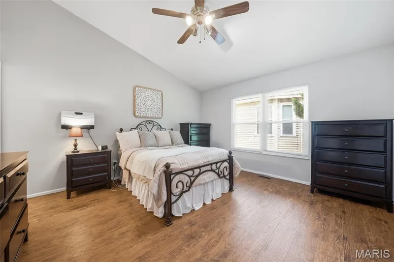 Spacious room featuring vaulted ceilings, wood-finish flooring, and white trim — 2510 Balaji Court, Wildwood, MO 63011