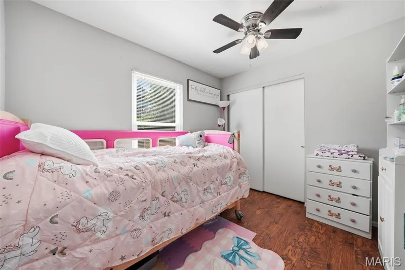 Bedroom featuring wood-finish flooring, a window with blinds, a ceiling fan with integrated lighting, and a closet with sliding doors — 2510 Balaji Court, Wildwood, MO 63011