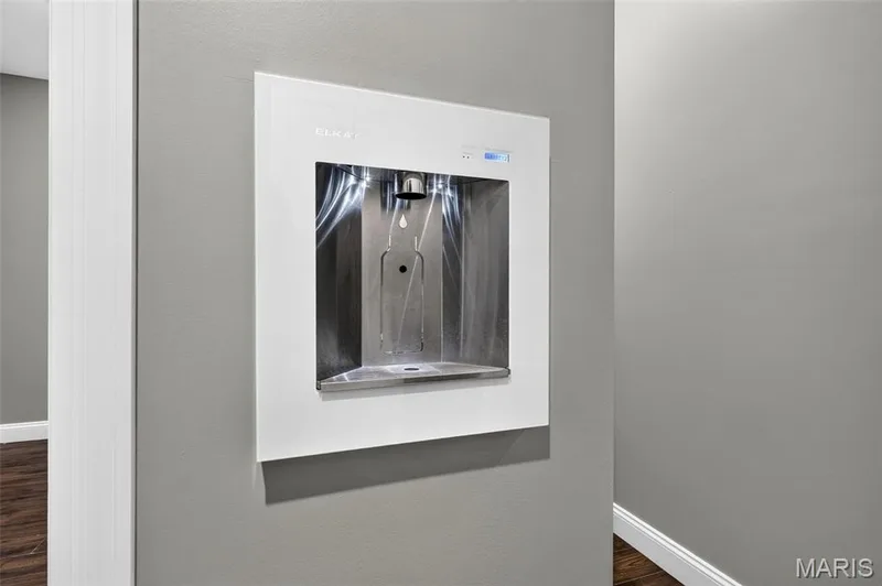 Built-in water dispenser with a stainless steel basin, finished with white trim and a digital display — 401 Hamlet Court, O'Fallon, MO 63367