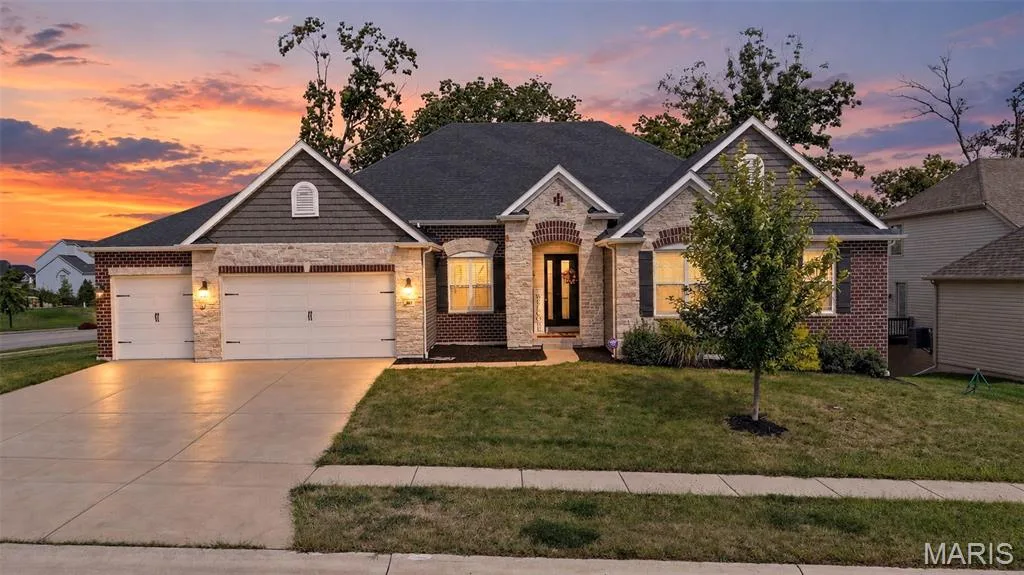 Brick and stone veneer exterior with dark shingle roofing — 401 Hamlet Court, O'Fallon, MO 63367