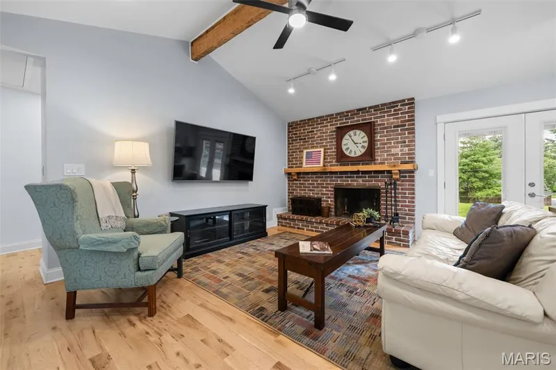 Vaulted family room with new hardwood floors and a wood burning fireplace — 312 Diplomat Lane, Chesterfield, MO 63017