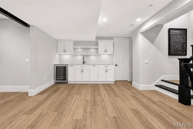 AI Cabinets. Cabinets/Bar do not exist. This is another AI suggestion for a different color. Rough ins for plumbing and electric are already there. — 16529 Waterfront Avenue, Chesterfield, MO 63017